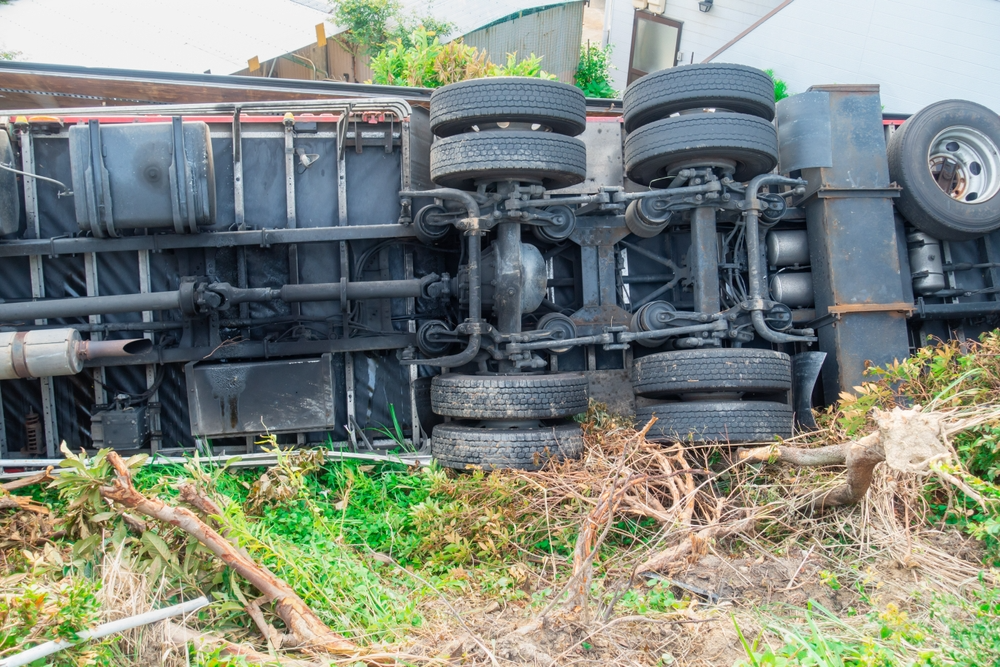 The exposed undercarriage and tires show the dramatic aftermath of the accident.